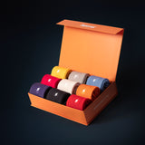 SuperSox premium gift box with nine pairs of ribbed socks in assorted colors neatly rolled inside an orange branded box.
